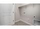 A well lit laundry room with a shelf, tile floor, and utility connections at 5649 N 205Th Ln, Buckeye, AZ 85396