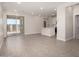 Open-concept living area featuring sleek tile flooring, recessed lighting, and glass sliding doors for natural light and indoor/outdoor flow at 5649 N 205Th Ln, Buckeye, AZ 85396