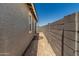 Side yard area with a concrete block wall and a window on the house's exterior at 5649 N 205Th Ln, Buckeye, AZ 85396