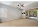 A spacious bedroom with a ceiling fan and sliding glass door to the patio at 7979 E Princess Dr # 13, Scottsdale, AZ 85255