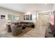 Bright living room with a comfortable seating area, large windows, and access to the front entrance at 7979 E Princess Dr # 13, Scottsdale, AZ 85255
