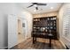 An office with a dark wooden desk and a large built-in bookcase at 7979 E Princess Dr # 13, Scottsdale, AZ 85255