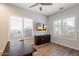 Cozy office space featuring a desk, TV, and window with plantation shutters at 7979 E Princess Dr # 13, Scottsdale, AZ 85255