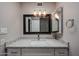 Bathroom featuring a granite countertop, a wood framed mirror, vanity lights, and a sink at 9346 E Citrus N Ln, Sun Lakes, AZ 85248