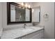 Updated bathroom featuring vanity with granite countertop, framed mirror, and updated lighting at 9346 E Citrus N Ln, Sun Lakes, AZ 85248