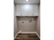 This is a well-lit laundry room that offers practical storage with white cabinets and modern utility connections at 9346 E Citrus N Ln, Sun Lakes, AZ 85248