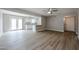 Bright and airy living room featuring wood-look flooring, ceiling fan, and access to the outdoor patio at 9346 E Citrus N Ln, Sun Lakes, AZ 85248