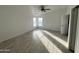 Bright bedroom with wood-look floors and ceiling fan at 12601 S Hermit Rd, Buckeye, AZ 85326