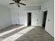 Bright bedroom with wood-look floors and ceiling fan at 12601 S Hermit Rd, Buckeye, AZ 85326