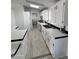 White kitchen with tile floor, island, and stainless steel appliances at 12601 S Hermit Rd, Buckeye, AZ 85326