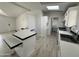 Kitchen with white cabinetry, an island, and stainless steel appliances at 12601 S Hermit Rd, Buckeye, AZ 85326