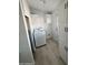 Laundry room with white cabinets and tile floor at 12601 S Hermit Rd, Buckeye, AZ 85326