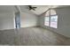 Living room with vaulted ceiling, large windows and wood-look floors at 12601 S Hermit Rd, Buckeye, AZ 85326