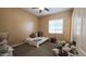 Cozy bedroom with a comfortable bed and window seat at 2285 E Mead Dr, Gilbert, AZ 85298