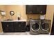 Bright laundry room, washer, dryer, cabinets, and sink at 2285 E Mead Dr, Gilbert, AZ 85298