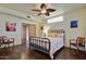 Inviting bedroom with hardwood floors, ceiling fan, and plenty of natural light at 6411 S River Dr # 26, Tempe, AZ 85283
