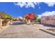 Gated community entrance with a mature tree and well-maintained landscaping at 6411 S River Dr # 26, Tempe, AZ 85283