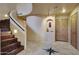 Entry foyer with tile floors, spiral staircase and wooden doors at 6411 S River Dr # 26, Tempe, AZ 85283