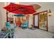 Inviting outdoor patio with colorful seating and a red umbrella at 6411 S River Dr # 26, Tempe, AZ 85283