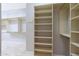 Large walk-in closet with custom shelving at 6486 E Oberlin Way, Scottsdale, AZ 85266