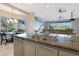 Kitchen island with double sinks, granite counters, and breakfast bar at 6486 E Oberlin Way, Scottsdale, AZ 85266