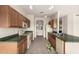 Kitchen with wood cabinets, green countertops, and tile floor at 1211 E Torrey Pines Ln, Chandler, AZ 85249