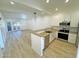 Modern kitchen with stainless steel appliances and light wood flooring at 1217 N Miller Rd # 8, Scottsdale, AZ 85257