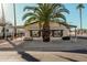 Tan single-wide manufactured home with covered carport, mature palm trees, and rock landscaping at 16246 N 32Nd Way, Phoenix, AZ 85032