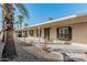 Covered patio with seating area, mature palm trees, and rock landscaping at 16246 N 32Nd Way, Phoenix, AZ 85032