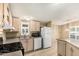 Kitchen with light wood cabinets, gas range, microwave, and dishwasher at 16246 N 32Nd Way, Phoenix, AZ 85032