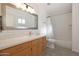 Clean bathroom with white subway tile and wood vanity at 2343 E Orangewood Ave, Phoenix, AZ 85020