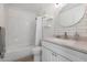 Clean bathroom with white subway tiles, a vanity with a quartz countertop, and a bathtub at 2343 E Orangewood Ave, Phoenix, AZ 85020