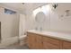 Modern bathroom with white subway tiles, wood vanity, and a bathtub at 2343 E Orangewood Ave, Phoenix, AZ 85020