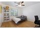 Bright bedroom with a double bed, window with shutters, and wood floors at 2343 E Orangewood Ave, Phoenix, AZ 85020