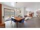 Bright dining area with wooden table and view to backyard at 2343 E Orangewood Ave, Phoenix, AZ 85020