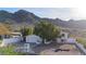 Single-story home with a white exterior, attached garage, and mountain views at 2343 E Orangewood Ave, Phoenix, AZ 85020