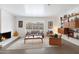 Living room with fireplace, large window, and mid-century modern decor at 2343 E Orangewood Ave, Phoenix, AZ 85020