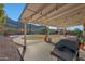 Covered patio with mountain views, grill, and string lights at 2343 E Orangewood Ave, Phoenix, AZ 85020