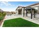 Stunning backyard with a pool, gazebo, travertine patio, and artificial grass at 4779 N 205Th Gln, Buckeye, AZ 85396