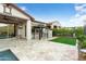 Spacious backyard boasts travertine patio, artificial grass, and a gazebo with an outdoor grill at 4779 N 205Th Gln, Buckeye, AZ 85396