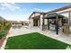 Stunning backyard with a pool, gazebo, travertine patio, and artificial grass at 4779 N 205Th Gln, Buckeye, AZ 85396