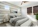 Relaxing bedroom with neutral tones, wood-look accent wall, and comfortable furnishings at 4779 N 205Th Gln, Buckeye, AZ 85396