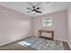 Light pink bedroom with wood-look floors and a small console table at 4830 E Palm Ln, Phoenix, AZ 85008