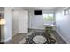 Cozy bedroom featuring light grey walls, wood floors, a large rug, and a wall mounted television at 14401 W Gunsight Dr, Sun City West, AZ 85375