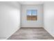 Spacious bedroom featuring wood-look floors and a window at 20105 W Campbell Ave, Buckeye, AZ 85396