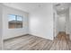 Bright bedroom with wood-look floors and large window at 20105 W Campbell Ave, Buckeye, AZ 85396