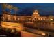 Night view of the Verrado Golf Club clubhouse featuring illuminated building and decorative fountain at 20105 W Campbell Ave, Buckeye, AZ 85396