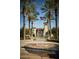 Community fountain with palm trees and the American flag in the background in front of a clock tower at 20105 W Campbell Ave, Buckeye, AZ 85396