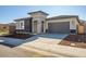 Modern single story home with gray exterior and a two car garage at 20105 W Campbell Ave, Buckeye, AZ 85396