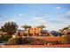 The Heritage Swim Park entrance boasts manicured landscaping and classic brick architecture against a blue sky with light clouds at 20105 W Campbell Ave, Buckeye, AZ 85396